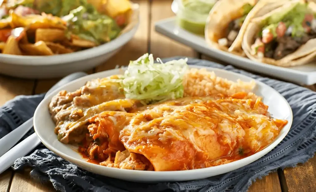 enchilada , mexican enchilada platter with red sauce, refreied beans and rice